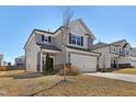 Charming two-story home with a two-car garage, neutral siding and manicured lawn at 2105 Attend Xing, Fuquay Varina, NC 27526