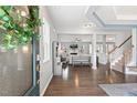 Open foyer with hardwood floors, staircase, and a seamless transition to the living area at 244 W Copenhaver Dr, Clayton, NC 27527