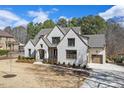 Elegant white brick home with attached garage and pristine landscaping at 278 Crimson Oak Dr, Durham, NC 27713