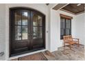 Charming covered porch with double glass doors and stone flooring at 278 Crimson Oak Dr, Durham, NC 27713