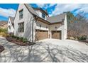 Spacious three-car garage with stylish doors and adjacent manicured landscape beds at 278 Crimson Oak Dr, Durham, NC 27713