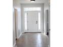 Bright foyer with decorative glass details above the front door and tile flooring at 3109 Benton Cir, Raleigh, NC 27615