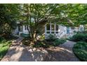 Charming home exterior with a large tree, showcasing beautiful landscaping and a well-maintained facade at 3601 Swann St, Raleigh, NC 27612