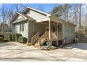 Attractive home with a covered porch, wooden deck, and beautiful landscaping at 3741 Manly Farm Rd, Wake Forest, NC 27587