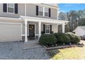Close up of the home's covered front porch, with landscaping and a stone accent at 40 Golden Timber Cir, Four Oaks, NC 27524