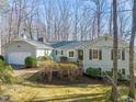 Well-maintained ranch style home with an attached garage with mature landscaping in a serene wooded setting at 405 Lookout Pt, Rougemont, NC 27572