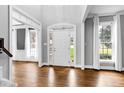Bright foyer with hardwood floors, large windows, and a decorative front door with sidelights at 521 Lyndenbury Dr, Apex, NC 27502