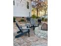 Outdoor patio area with stylish Adirondack chairs, a fire pit, and a built-in grill station at 528 Opposition Way Way, Wake Forest, NC 27587