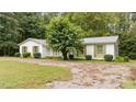 Charming single-story home with well-manicured bushes surrounding the perimeter at 7101 Winding Way, Wake Forest, NC 27587
