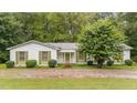 Charming single-story home with well-manicured bushes surrounding the perimeter at 7101 Winding Way, Wake Forest, NC 27587