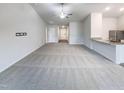 Open-concept living space with carpet and a view of kitchen with granite countertops at 737 Little Patch St, Zebulon, NC 27597