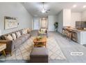 Bright, open living room featuring plush seating, neutral tones and seamless flow to the kitchen and dining area at 737 Little Patch St, Zebulon, NC 27597