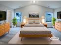 Serene main bedroom with natural light, neutral color palette, and coordinated furniture creating a peaceful retreat at 737 Little Patch St, Zebulon, NC 27597