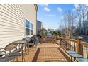 Spacious wooden deck with outdoor kitchen, grill, and seating area at 7520 Channery Way, Raleigh, NC 27616