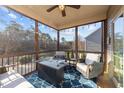 Cozy screened porch with comfortable seating, a ceiling fan, and backyard views at 7520 Channery Way, Raleigh, NC 27616