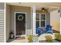 Inviting front porch with a welcoming wreath on the front door and comfortable seating at 86 Cecina Ct, Clayton, NC 27527