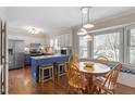 Eat-in kitchen with updated appliances, a breakfast bar with seating, and a window-filled dining nook at 8617 Canoe Ct, Raleigh, NC 27615