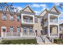 Charming townhome showcasing balconies, brick accents, and well-maintained landscaping at 10510 Sablewood Dr # 108, Raleigh, NC 27617