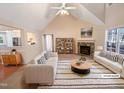 Bright, virtually staged living room with vaulted ceilings, fireplace and neutral decor at 110 Chickasaw Cir, Clayton, NC 27527
