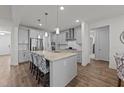 Modern kitchen boasts gray cabinets, a granite island with seating, and stainless steel appliances at 112 Ava Ct, Holly Springs, NC 27540