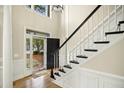 Elegant foyer with hardwood floors, decorative trim, and staircase at 113 Preston Pines Dr, Cary, NC 27513