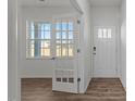 Bright foyer featuring a window, decorative french door, and a classic paneled front door at 117 Pisgah St, Sanford, NC 27330