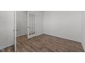 View of a well-lit office space showcasing wood flooring and a glass paneled door at 117 Pisgah St, Sanford, NC 27330