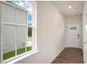 Bright entryway with wood-look floors, a window to the left, and a white front door at 120 Pisgah St, Sanford, NC 27330