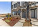 A townhome's inviting entrance is accentuated by meticulous landscaping and a concrete walkway, enhancing its curb appeal at 1257 S Blount Street # 201, Raleigh, NC 27601
