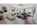 Bright living room featuring modern decor, lots of natural light, stylish furniture, and hardwood floors at 131 E Victory View. Ter, Smithfield, NC 27577