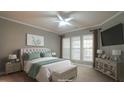 Cozy bedroom featuring a comfortable bed, bedside tables and lamps, neutral tones and a ceiling fan at 136 Sabiston Ct, Cary, NC 27519