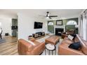 Open-concept living room with fireplace, arch-top windows and views into the kitchen at 1617 Jenkins Rd, Wake Forest, NC 27587