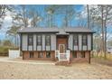 Charming two-story home with gray siding, brick foundation, and a well-manicured lawn at 1911 Stadium Dr, Durham, NC 27705