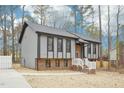 Charming two-story home with gray siding, brick foundation, and a well-manicured lawn at 1911 Stadium Dr, Durham, NC 27705