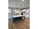 Bright kitchen features a spacious island with marble countertops, stainless steel appliances, and white cabinetry at 1912 Harrell Cove Ct # 171 Gunnison Cr, Fuquay Varina, NC 27526