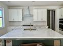 Kitchen features white cabinets, marble countertops, a stylish backsplash, and modern stainless steel appliances at 1912 Harrell Cove Ct # 171 Gunnison Cr, Fuquay Varina, NC 27526