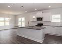 Bright kitchen with white cabinets, granite countertops, and stainless steel appliances at 20 Watermelon Dr, Franklinton, NC 27525