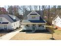 An aerial shot showcases this lovely home with its inviting front porch and neat landscaping at 206 Pine St, Fuquay Varina, NC 27526