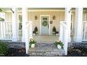 Welcoming front porch with stone steps, decorative plants, and a charming entryway at 206 Pine St, Fuquay Varina, NC 27526