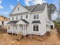 Charming two-story home features a classic design with a covered porch and detailed trim at 207 Holleman St, Apex, NC 27502