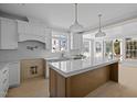 Bright kitchen with a spacious center island, pendant lighting, and natural light at 207 Holleman St, Apex, NC 27502