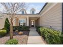 Inviting front porch with manicured bushes lining the sidewalk to the front door at 216 Kalmia Dr, Durham, NC 27703