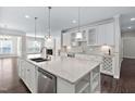 Spacious kitchen island with stainless steel dishwasher and granite countertops at 216 Kalmia Dr, Durham, NC 27703
