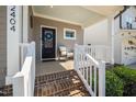 Inviting front porch with a chair and a wreath on the door, creating a warm welcome at 2404 Glade Mill Ct, Fuquay Varina, NC 27526