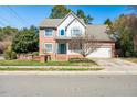 Beautiful two-story brick home featuring blue shutters, attached garage, and landscaped front yard at 2428 Havershire Dr, Raleigh, NC 27613