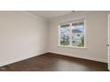 Bedroom with hardwood floors, large windows providing natural light, and white trim throughout at 265 Umstead St, Sanford, NC 27330