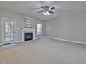 Spacious living room featuring a cozy fireplace and a ceiling fan for added comfort at 273 Homestead Way, Clayton, NC 27527