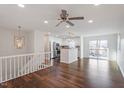 Open concept living space with modern lighting, hardwood floors, and stainless steel appliances at 305 Cliffview Dr, Knightdale, NC 27545