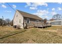 Back exterior view of home showing wooden deck and yard at 3307 Altamahaw Church St, Elon, NC 27244