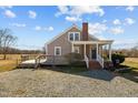 Rear exterior view of home showing wooden deck and gravel driveway at 3307 Altamahaw Church St, Elon, NC 27244